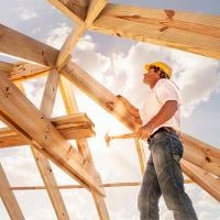 Construction worker framing a roof